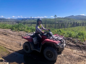 Reforestation crew leader Kerry Gibson against the backdrop of the MLIB Treaty 8 Lands at Kerry Lake, BC.